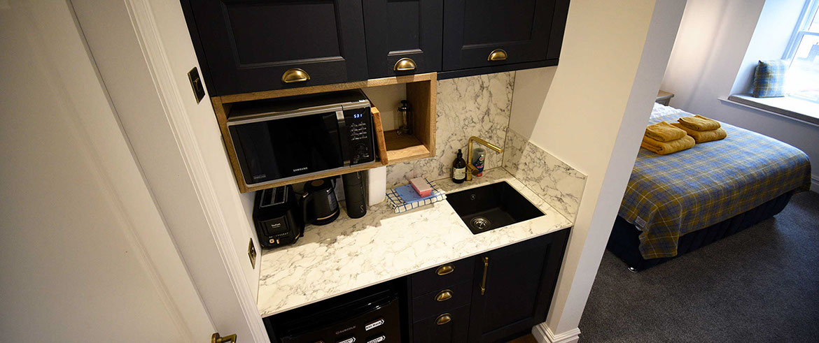 Somerled House Suites self catering apartment accommodation contains a kitchenette with toaster kettle oven and microwave