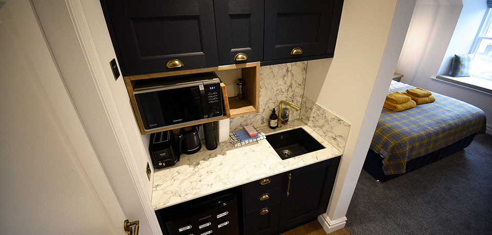 Somerled House Suites self catering apartment accommodation contains a kitchenette with toaster kettle oven and microwave