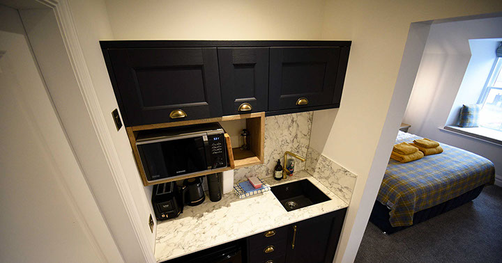 Somerled House Suites self catering apartment accommodation contains a kitchenette with toaster kettle oven and microwave