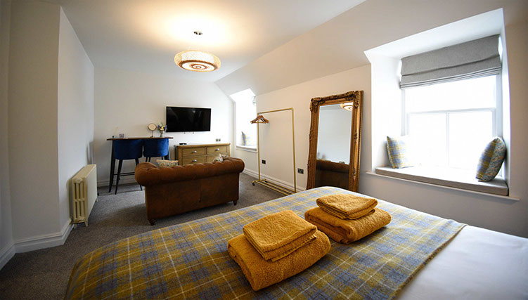 Somerled House Suites Room 5 contains a widescreen smart TV and cosy seating area at our Portree accommodation