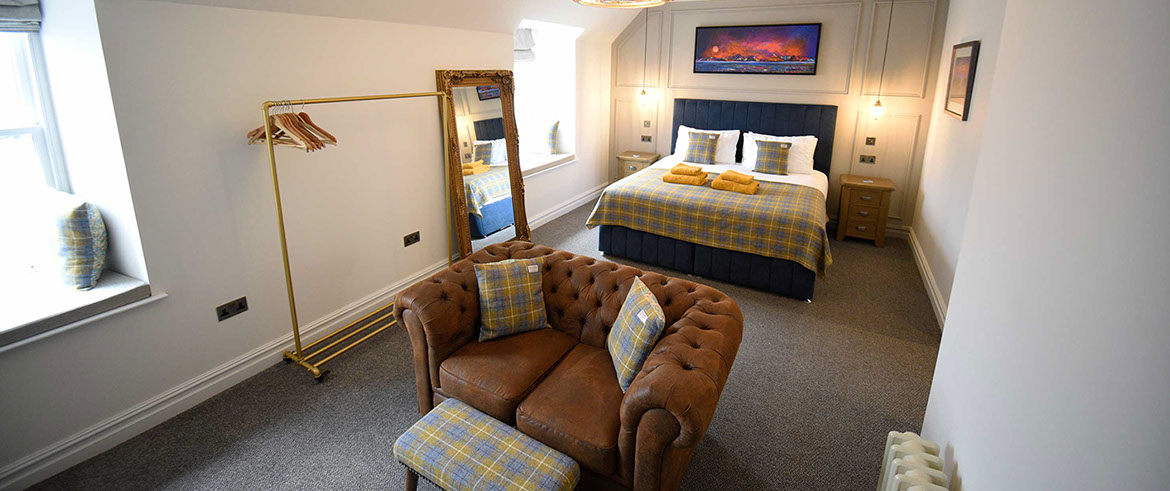 Somerled House Suites contain a King size bed with all bedding and linen provided and a cost seating area with widescreen TV
